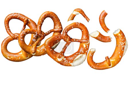 German baked Salted pretzels on a wooden rustic table. Isolated on white background