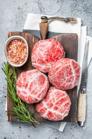 Raw Caul Fat Meatballs burger cutlets, fresh meat. Gray background. Top view.