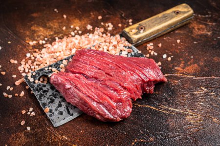 Butcher board with Raw Venison dear meat steak. Dark background. Top view.