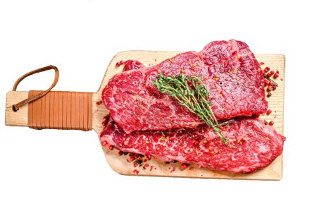 Marble beef Denver steak on a cutting board. Isolated on white background. Top view