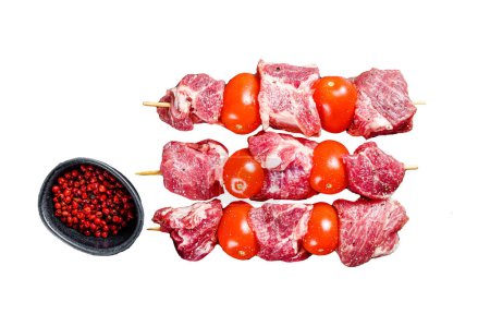 Raw beef meat kebab. BBQ with tomato and spices. Isolated on white background. Top view
