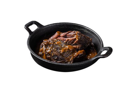 Stewed beef cheeks with brown red wine sauce in skillet Isolated on white background. Top view
