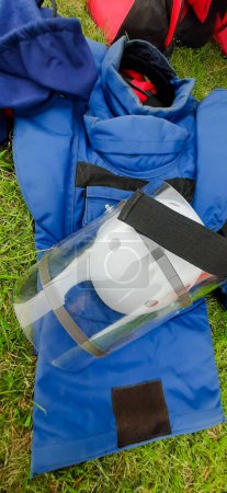 Visor and kevlar vest, deminer protection, and bag with his tools. Cleaning of territories contaminated by land mines. The process of humanitarian demining.