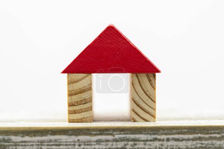 Photo for Miniature house formed with wooden dowels on a white background - Royalty Free Image