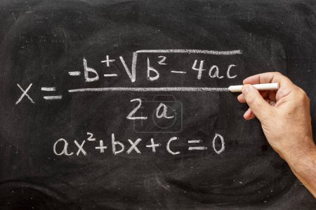 Téléchargez les photos : Équations quadratiques manuscrites sur un tableau noir à la craie, formules mathématiques - en image libre de droit