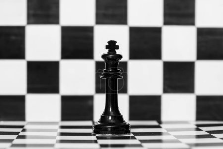 The figure of the king on a chess board, in black and white