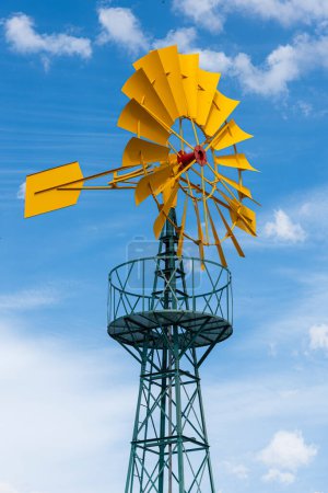 Photo for Windmill for pumping water with the sky in the background - Royalty Free Image