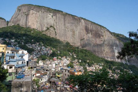 Photo for Brazil: the mountains and skyline of Rocinha, the famous favela in the southern area of Rio de Janeiro, the largest slum in the country between Gavea, Sao Conrado and Vidigal districts - Royalty Free Image