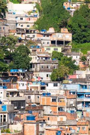 Photo for Brazil: skyline and detail view of Rocinha, the famous favela in the southern area of Rio de Janeiro, the largest slum in the country between Gavea, Sao Conrado and Vidigal districts - Royalty Free Image