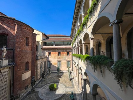 Photo for Pinacoteca Ambrosiana, Milan, Italy, 07-09-2023: the Courtyard of the Great Spirits, designed by prefect Giovanni Galbiati in 1932 and named after the verses of Inferno (canto IV) where Dante sees the great men of poetry, science, culture in Limbo - Royalty Free Image