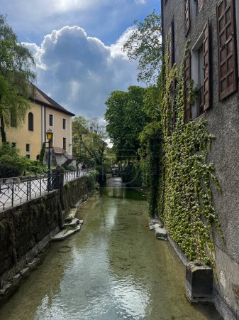 Annecy, Haute-Savoie, Frankreich, 21.4.2024: die Skyline der Altstadt und das kristallklare Wasser des Flusses Thiou, der in einem der Kanäle fließt, die Annecy als französisches Venedig berühmt gemacht haben
