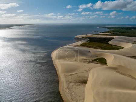 Aerial view of Parque da Dunas - Ilha das Canarias, Brazil. Huts on the Delta do Parnaba and Delta das Americas. Lush nature and sand dunes. Boats on the river bank