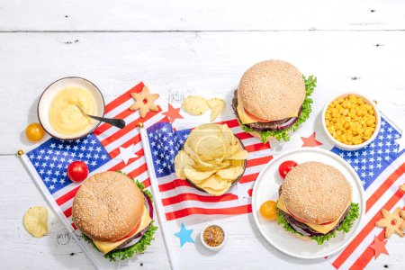 Photo for Homemade burgers. An American classic, traditional food for picnic, party or celebration Independence Day. Hard light, dark shadow, flat lay, white wooden background, top view - Royalty Free Image