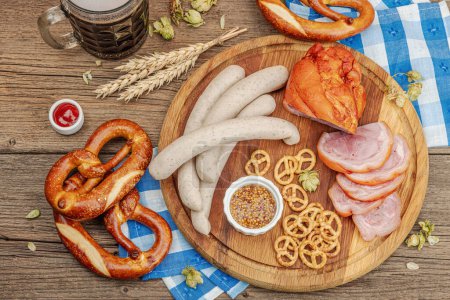 Photo for Traditional Oktoberfest set. Pretzels, beer, weisswurst and eisbein with mustard. German festival food concept. Trendy wooden background, top view - Royalty Free Image