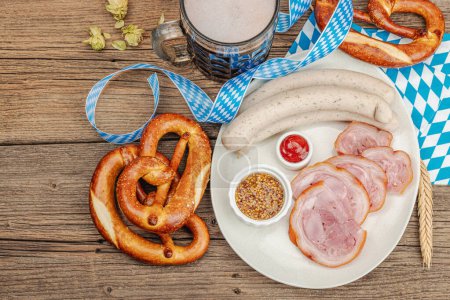 Photo for Traditional Oktoberfest set. Pretzels, beer, weisswurst and eisbein with mustard. German festival food concept. Trendy wooden background, top view - Royalty Free Image
