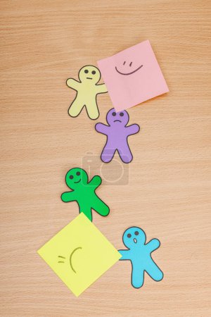 Photo for World mental health day. Paper men figures with different emotions. Feedback rating, customer review, experience, satisfaction survey or assessment concept, flat lay, wooden table, top view - Royalty Free Image