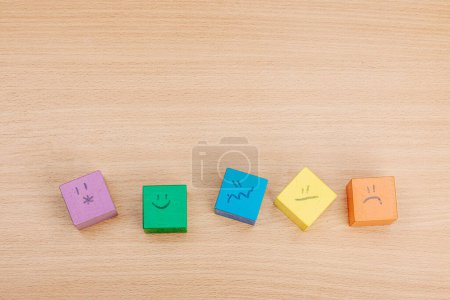 Photo for World mental health day. wooden cubes with different emotions. Feedback rating, customer review, experience, satisfaction survey or assessment concept, flat lay, top view - Royalty Free Image