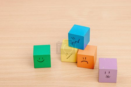 Photo for World mental health day. wooden cubes with different emotions. Feedback rating, customer review, experience, satisfaction survey or assessment concept, flat lay - Royalty Free Image