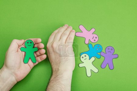Photo for World mental health day. Male hands holding paper men figures with different emotions. Feedback rating, customer review, experience, satisfaction survey or assessment concept, flat lay - Royalty Free Image