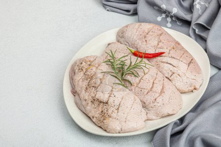 Photo for Raw duck breast with fresh spices and herbs, ready to cook food. Domestic tasty cuisine, poultry meat fillet. Light stone concrete background, copy space - Royalty Free Image