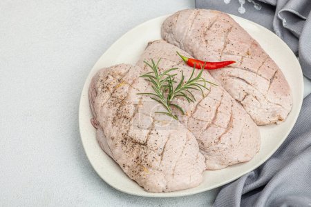 Photo for Raw duck breast with fresh spices and herbs, ready to cook food. Domestic tasty cuisine, poultry meat fillet. Light stone concrete background, copy space - Royalty Free Image