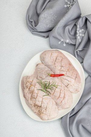 Photo for Raw duck breast with fresh spices and herbs, ready to cook food. Domestic tasty cuisine, poultry meat fillet. Light stone concrete background, top view - Royalty Free Image