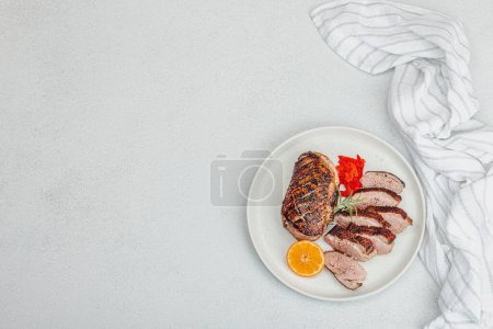 Photo for Fried duck breast with fresh orange and ginger, ready to eat food. Domestic tasty cuisine, poultry meat fillet. Light stone concrete background, top view - Royalty Free Image