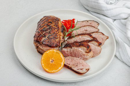 Photo for Fried duck breast with fresh orange and ginger, ready to eat food. Domestic tasty cuisine, poultry meat fillet. Light stone concrete background, close up - Royalty Free Image