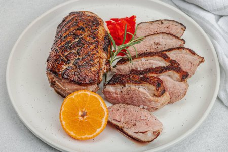 Photo for Fried duck breast with fresh orange and ginger, ready to eat food. Domestic tasty cuisine, poultry meat fillet. Light stone concrete background, close up - Royalty Free Image