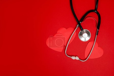 Red hearts with stethoscope on red background, heart health, health insurance concept, world health day, Valentine's day
