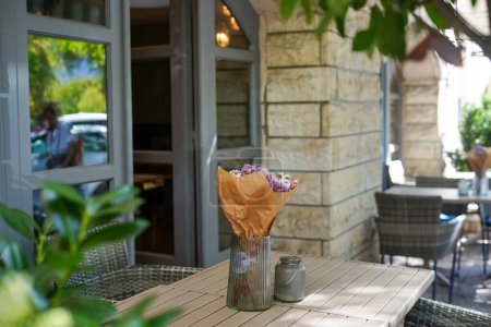 Photo for Cozy outdoor cafe with dried flowers on the table - Royalty Free Image