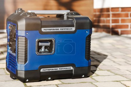 Foto de Portable Generator Close up Outdoors. Gasoline Inverter Generator Provides with Electricity to House. - Imagen libre de derechos