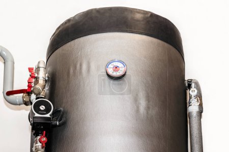 Téléchargez les photos : Boiler Tank with Pipes, Pump, Thermometer, Valves of Water Heating System of House. Close up, isolated on White Background. - en image libre de droit
