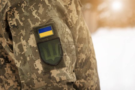 Ukraine Army Background. Ukrainian flag Symbol on Ukrainian Armed Forces Soldier Camouflage Uniform.