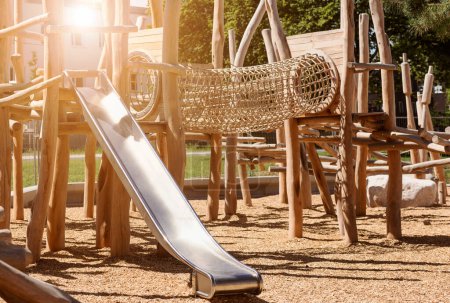 Photo for Children Playground  on Public Yard in Park with Swings, Slides and Climbing Equipment. Modern Wooden Playground Equipment of Entertainment Park for Kids. - Royalty Free Image