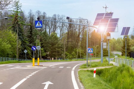 Photo for Solar Panel and Windmill Energy on Road with Traffic Light, Road Signs, Pedestrian Crossing. Green energy element on Eco Road. - Royalty Free Image