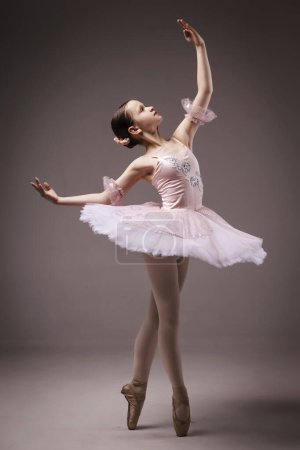 Photo for Ballerina. Young Graceful Girl Teen Ballet Dancer, dressed in Professional Outfit, Ballet Shoes and Pink Tutu Skirt. Beautiful Teenager of Classic Ballet Dance - Royalty Free Image