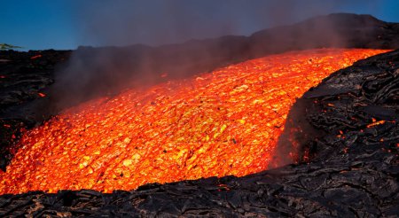 Photo for Volcanic lava river burning in flames cascading down - Royalty Free Image