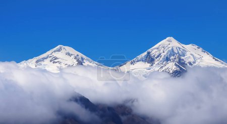 Photo for Majestic snow covered mountains aerial view with clouds - Royalty Free Image