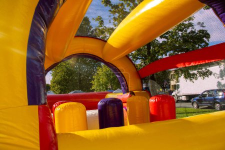 Photo for Yellow red purple fun inflatable fun house for childern to play - Royalty Free Image