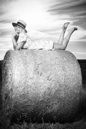 Photo for Monochrome portrait of a pretty lady in summer apparel posing on harvested cornfield - Royalty Free Image