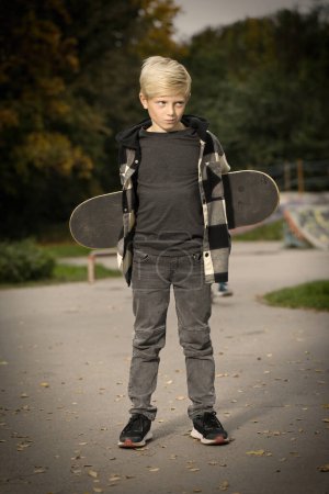 Foto de Niño posando al aire libre en skate park con tabla de skate - Imagen libre de derechos