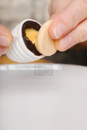 Photo for Filling of traditional christmas sweets bee hives with yolk creme - Royalty Free Image