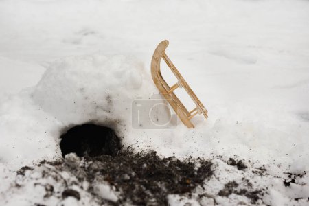 Photo for Ferret burrow made in snow igloo house with propped toboggan - Royalty Free Image
