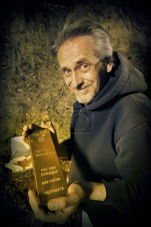 Photo for Adventurer with metal detector found a WW2 deposit of German gold - Royalty Free Image