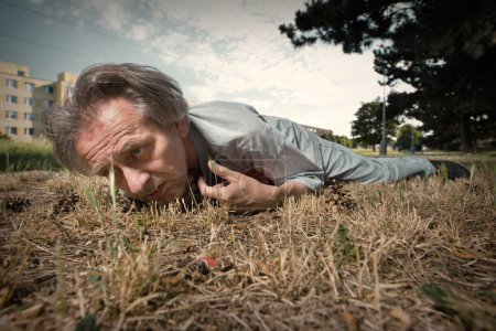 Photo for Addicted old man drunked in summer city park inable to walk - Royalty Free Image