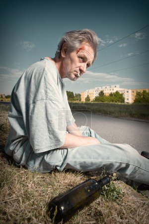 Photo for Addicted old man drunked in summer city park inable to walk - Royalty Free Image