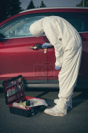 Photo for Crime scene investigation - finding and developing of fingerprints in car - Royalty Free Image