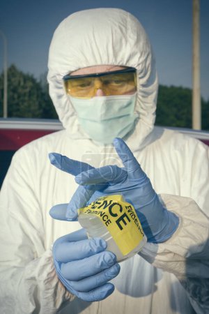 Photo for Crime scene investigation - collecting of evidences of soil samples on car wheel - Royalty Free Image