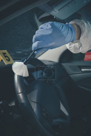 Photo for Crime scene investigation - finding and developing of fingerprints in car - Royalty Free Image